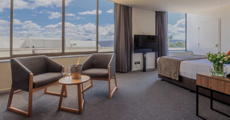 Deluxe Accessible King room at Wrest Point with spacious layout, seating area and large windows