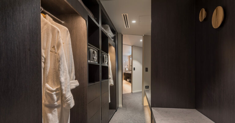 Harbour Suite walk-in wardrobe at Wrest Point with robes, shelving and safe