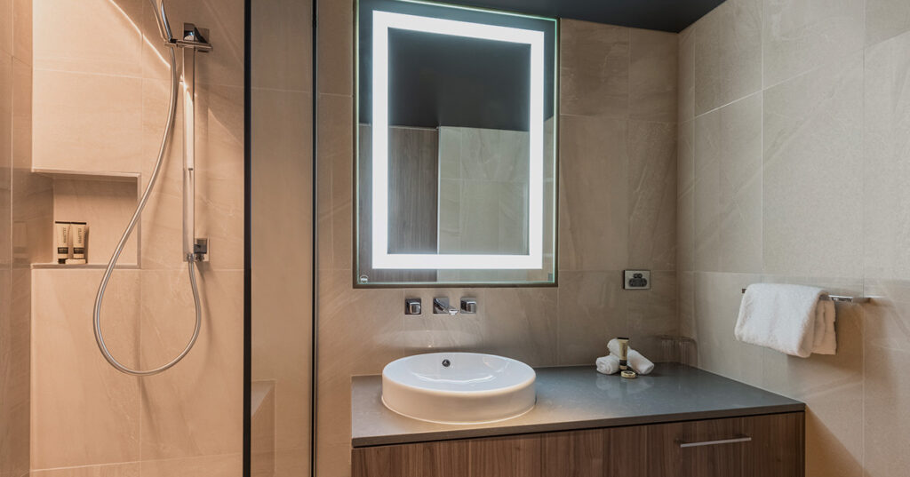 Harbour View Deluxe King bathroom at Wrest Point with backlit mirror and walk-in shower