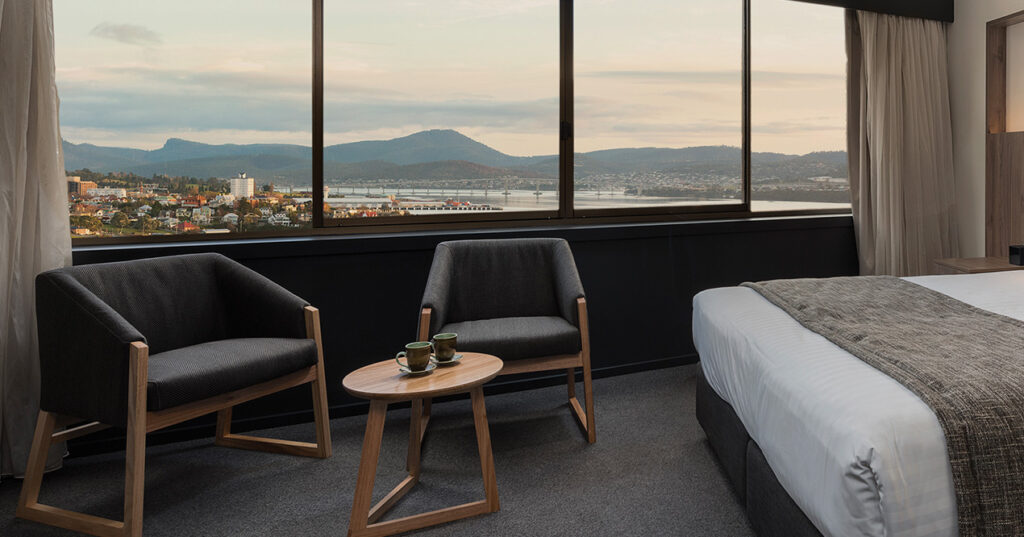 Evening harbour outlook from Wrest Point Harbour View Deluxe King with cosy seating