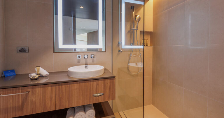 Harbour View Deluxe bathroom at Wrest Point with illuminated mirror and glass shower