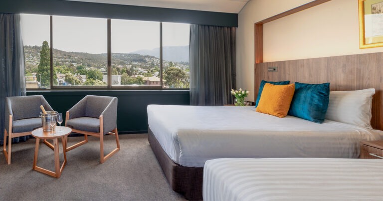 Mountain View Deluxe Twin room at Wrest Point with two beds, armchairs and mountain outlook