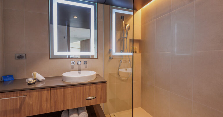 Mountain View Deluxe bathroom at Wrest Point with illuminated mirror and walk-in shower